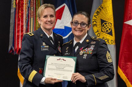 Brig. Gen. Paige M. Jennings, Office of Joint Chiefs of Staff Manpower and Personnel director, presents a Legion of Merit to Sgt. Maj. Julie D. Harris, U.S. Army Financial Management Command Operations senior enlisted advisor, during Harris’ retirement ceremony at the Maj. Gen. Emmett J. Bean Federal Center in Indianapolis Nov. 25, 2024. Harris retired from the U.S. Army after more than 22 years of service. (U.S. Army photo by Mark R. W. Orders-Woempner)