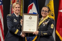 Brig. Gen. Paige M. Jennings, Office of Joint Chiefs of Staff Manpower and Personnel director, presents a certificate of retirement to Sgt. Maj. Julie D. Harris, U.S. Army Financial Management Command Operations senior enlisted advisor, during Harris’ retirement ceremony at the Maj. Gen. Emmett J. Bean Federal Center in Indianapolis Nov. 25, 2024. Harris retired from the U.S. Army after more than 22 years of service. (U.S. Army photo by Mark R. W. Orders-Woempner)