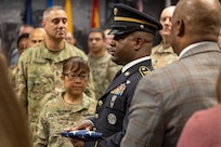 Sgt. 1st Class Deterrance Brown, U.S. Army Financial Management Command senior FM systems instructor, presents an American Flag to Sgt. Maj. Julie D. Harris, U.S. Army Financial Management Command Operations senior enlisted advisor, during Harris’ retirement ceremony at the Maj. Gen. Emmett J. Bean Federal Center in Indianapolis Nov. 25, 2024. Harris retired from the U.S. Army after more than 22 years of service. (U.S. Army photo by Mark R. W. Orders-Woempner)