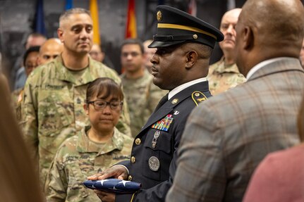 Sgt. 1st Class Deterrance Brown, U.S. Army Financial Management Command senior FM systems instructor, presents an American Flag to Sgt. Maj. Julie D. Harris, U.S. Army Financial Management Command Operations senior enlisted advisor, during Harris’ retirement ceremony at the Maj. Gen. Emmett J. Bean Federal Center in Indianapolis Nov. 25, 2024. Harris retired from the U.S. Army after more than 22 years of service. (U.S. Army photo by Mark R. W. Orders-Woempner)