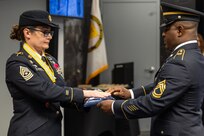 Sgt. 1st Class Deterrance Brown, U.S. Army Financial Management Command senior FM systems instructor, presents an American Flag to Sgt. Maj. Julie D. Harris, U.S. Army Financial Management Command Operations senior enlisted advisor, during Harris’ retirement ceremony at the Maj. Gen. Emmett J. Bean Federal Center in Indianapolis Nov. 25, 2024. Harris retired from the U.S. Army after more than 22 years of service. (U.S. Army photo by Mark R. W. Orders-Woempner)