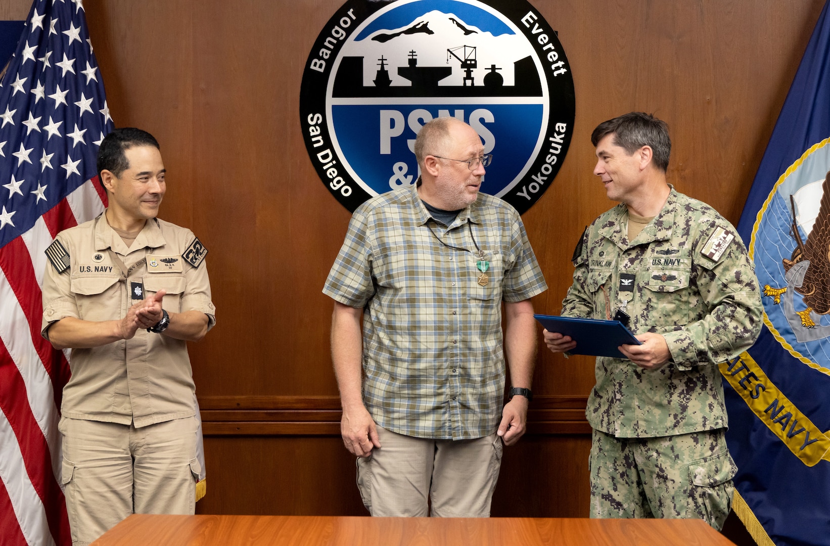 Capt. JD Crinklaw, commander, PSNS & IMF, and Cmdr. Andrew Ra, commander, USS Connecticut (SSN 22), present Earnest T. Ryan Jr., marine machinery supervisor, Shop 38, Marine Machinist, with the NCSC Medal May 28. (U.S. Navy photo by Wendy Hallmark)