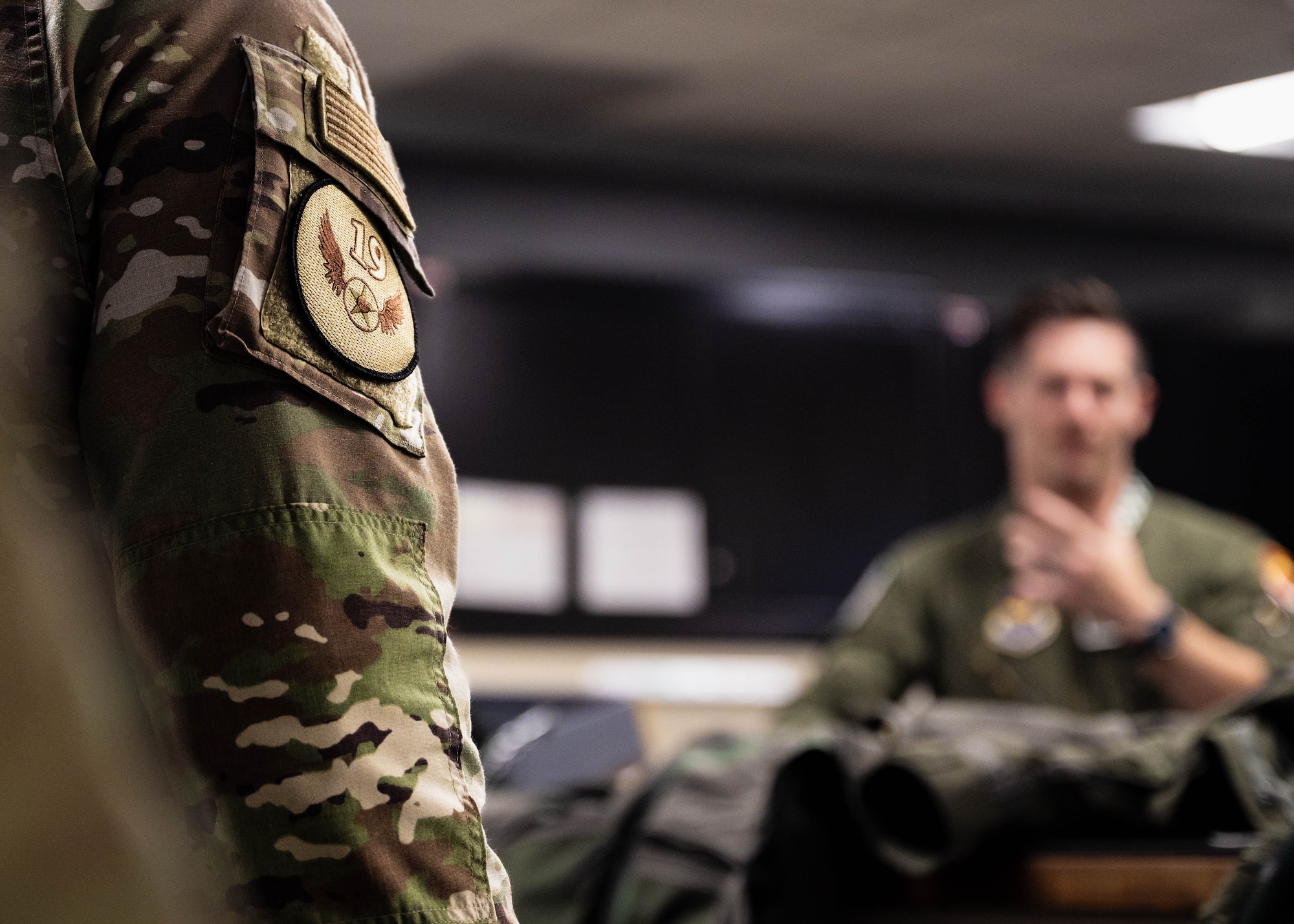 U.S. Air Force Chief Master Sgt. Keith Scott, 19th Air Force command chief, listens to a brief at the 308th Fighter Squadron