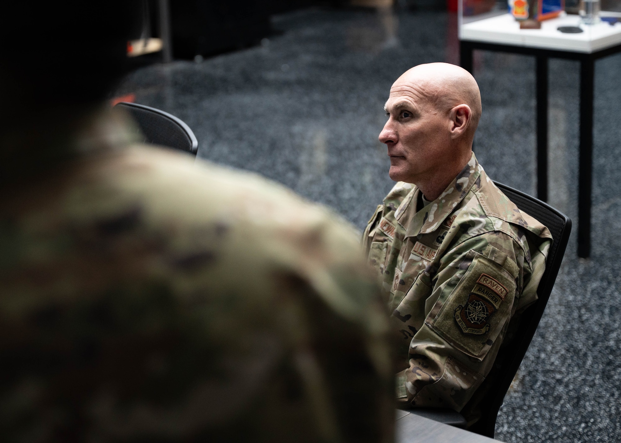 U.S. Air Force Chief Master Sgt. Jamie Newman, Headquarters Air Mobility Command command chief, listens to a brief