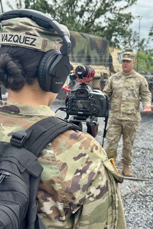 U.S. Army Staff Sgt. Melyssa Vazquez, a public affairs specialist with the 109th Mobile Public Affairs Detachment, 213th Regional Support Group, Pennsylvania Army National Guard, records a media interview with Maj. Kyle Freeman, commander of the 108th Medical Company Area Support, 213th RSG, during the 108th MCAS' medical evacuation exercise at Fort Indiantown Gap, Pennsylvania, July 18, 2025. The 108th MCAS was participating in a mass casualty exercise to enhance their readiness to treat patients in forward deployed locations. (U.S. Army National Guard photo by 1st Sgt. HollyAnn Nicom)