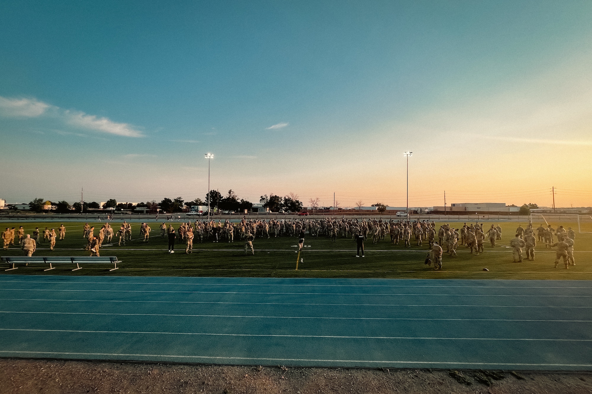 group of airmen stand on football field