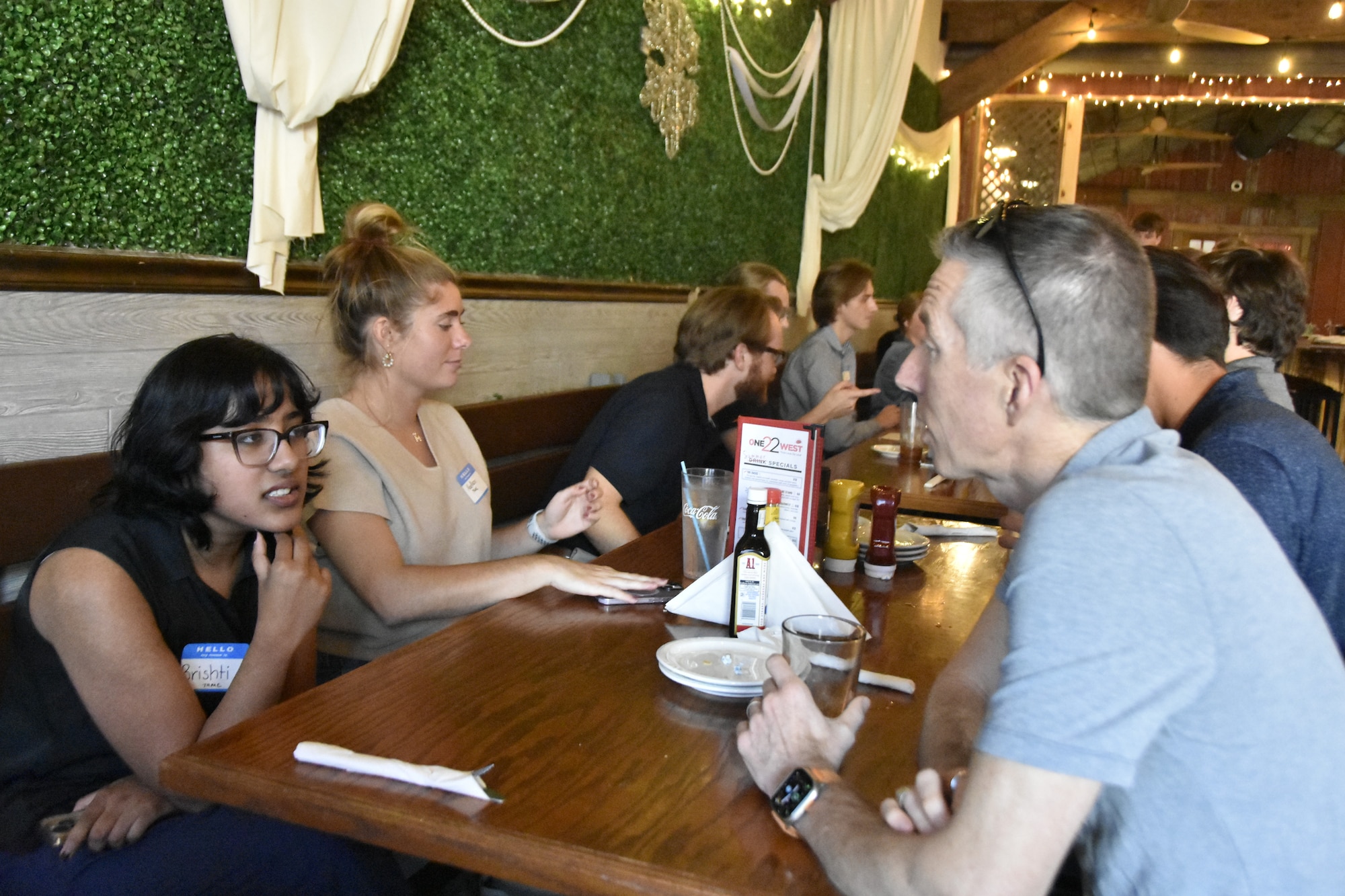 Brishti Chakraborty, a Test Resource Management Center-sponsored Air Force intern at Arnold Air Force Base, Tenn., left, speaks with Arnold Engineering Development Complex Commander Col. Grant Mizell during an icebreaker event for interns working at Arnold AFB this summer held June 11, 2025, at the One22West restaurant in Tullahoma, Tenn. AEDC is headquartered at Arnold AFB. This year, 21 interns with the Air Force and AEDC Test Operations and Sustainment and Technical Management and Advisory Services contractors worked at Arnold AFB, giving them experience in a professional setting. (U.S. Air Force photo by Brad Hicks)