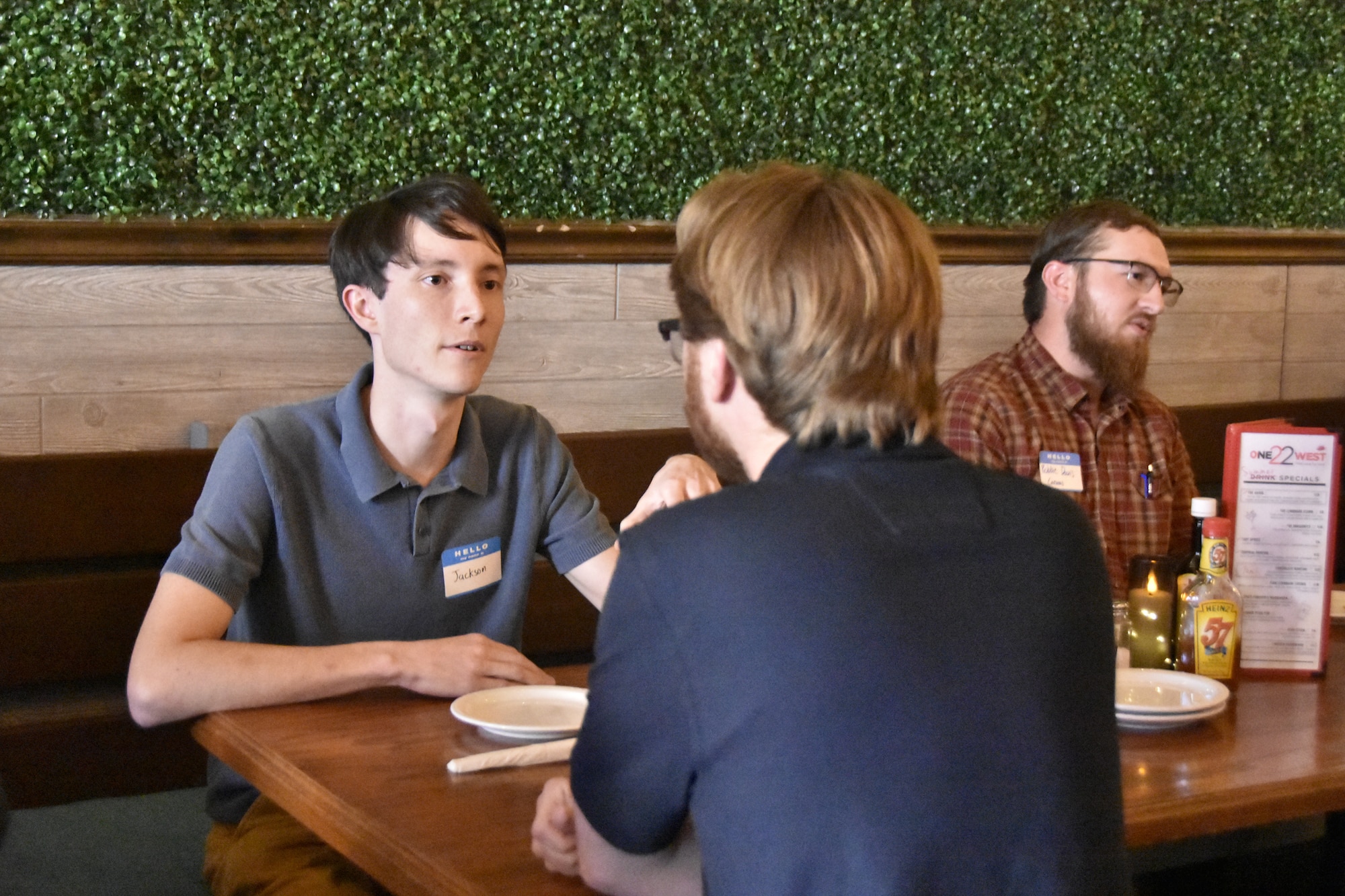 Jackson Boals, an intern with the Arnold Engineering Development Complex Test Operations and Sustainment contractor, left, speaks with Gabriel Bonneville, an intern with the Technical Management and Advisory Services contractor, during an icebreaker event for interns working at Arnold Air Force Base, Tenn., this summer held June 11, 2025, at the One22West restaurant in Tullahoma, Tenn. AEDC is headquartered at Arnold AFB. This year, 21 interns with the Air Force and AEDC Test Operations and Sustainment and Technical Management and Advisory Services contractors worked at Arnold AFB, giving them experience in a professional setting. (U.S. Air Force photo by Brad Hicks)