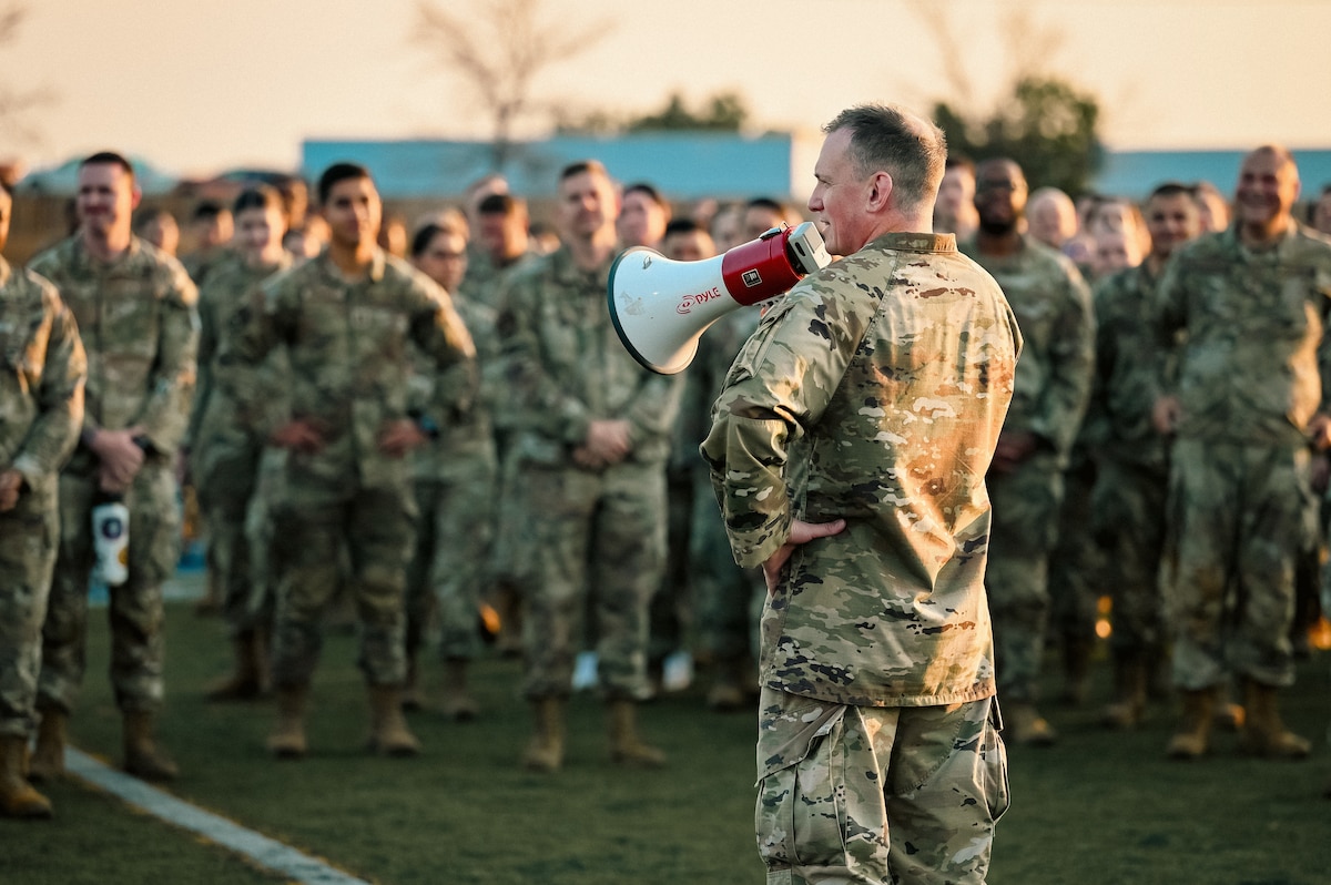 man speaks to audience through airhorn