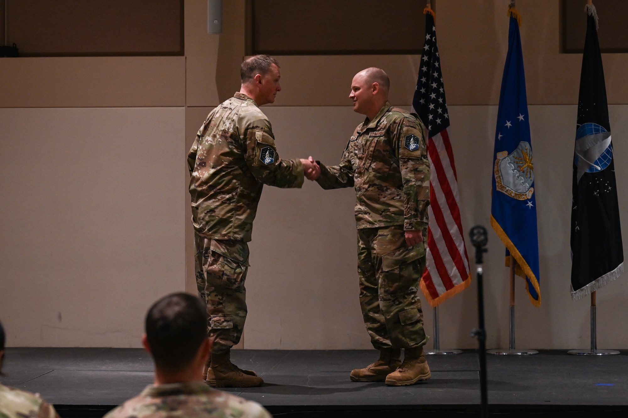 two men shake hands