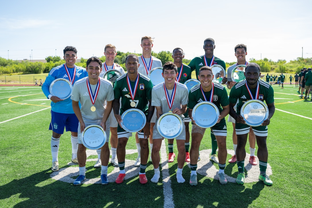 U.S. Army Soldiers and Air Force Airmen, recipients of the All-Tournament award, pose for a group photo at the award ceremony of the Armed Forces Men’s Soccer Championship in Phantom Warrior Stadium, Fort Hood, Texas, on July 30, 2025. Each team faces off in a bracket to determine which service will hold the championship title, featuring teams from the Army, Navy, and Air Force. (U.S. Army photo by Sgt. Tien Dat Ngo)