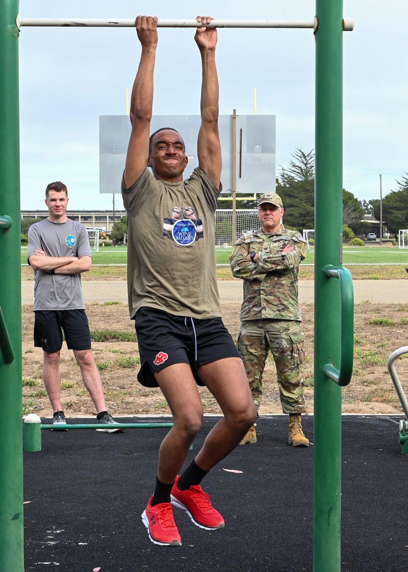 a person hangs from a pull up bar