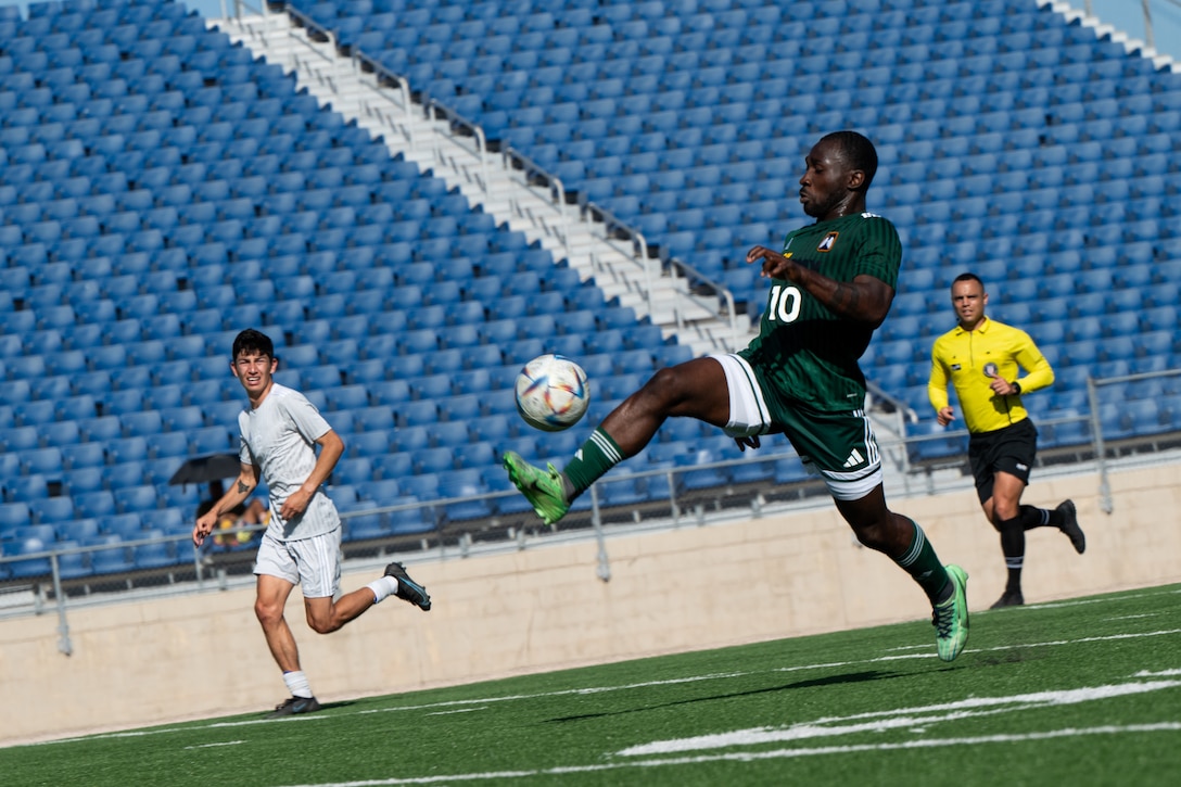 U.S. Army Staff Sgt. Samuel Eseyin, the striker, leads the ball towards the Air Force's goal during the Armed Forces Men’s Soccer Championship in Phantom Warrior Stadium, Fort Hood, Texas, on July 30, 2025. Each team faces off in a bracket to determine which service will hold the championship title, featuring teams from the Army, Navy, and Air Force. (U.S. Army photo by Sgt. Tien Dat Ngo)