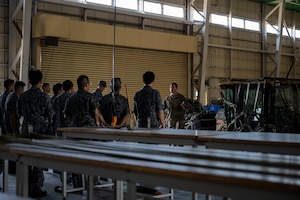 A U.S. military members speaks to a group of Japan Air Self-Defense Force members.