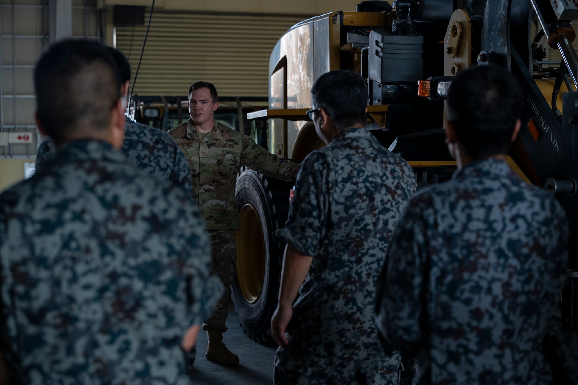 A U.S. military member speaks to Japan Air Self-Defense Force members.