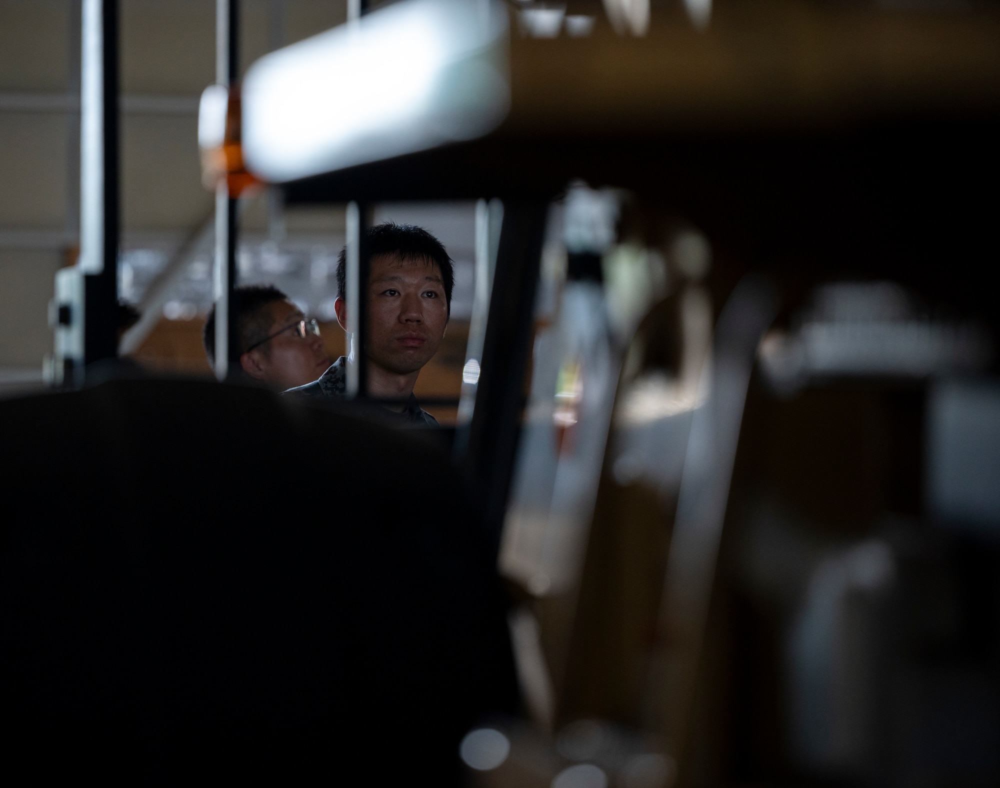 A Japan Air Self-Defense Force member looks at a piece of equipment.