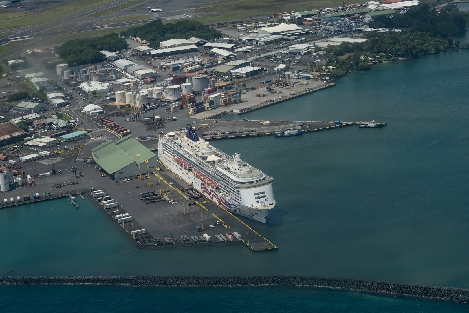 A crew from Coast Guard Air Station Barbers Point flies over Hilo Harbor, Big Island, July 30, 2025. The Coast Guard Captain of the Port Honolulu reopened all commercial harbors across the Hawaiian Islands following the end of a tsunami advisory that began July 29, 2025. (U.S. Coast Guard photo by Petty Officer 3rd Class Avery Tibbets)