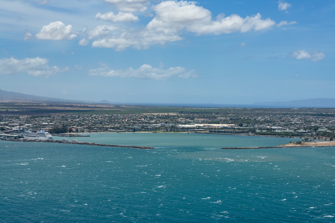 A crew from Coast Guard Air Station Barbers Point flies an HC-130 Hercules aircraft over Kahului Harbor, Maui, July 30, 2025. The crew assessed the condition of harbors, waterways, and aids to navigation across the Hawaiian Islands following the end of a tsunami advisory that had been issued across Hawaii. (U.S. Coast Guard photo by Petty Officer 3rd Class Avery Tibbets)