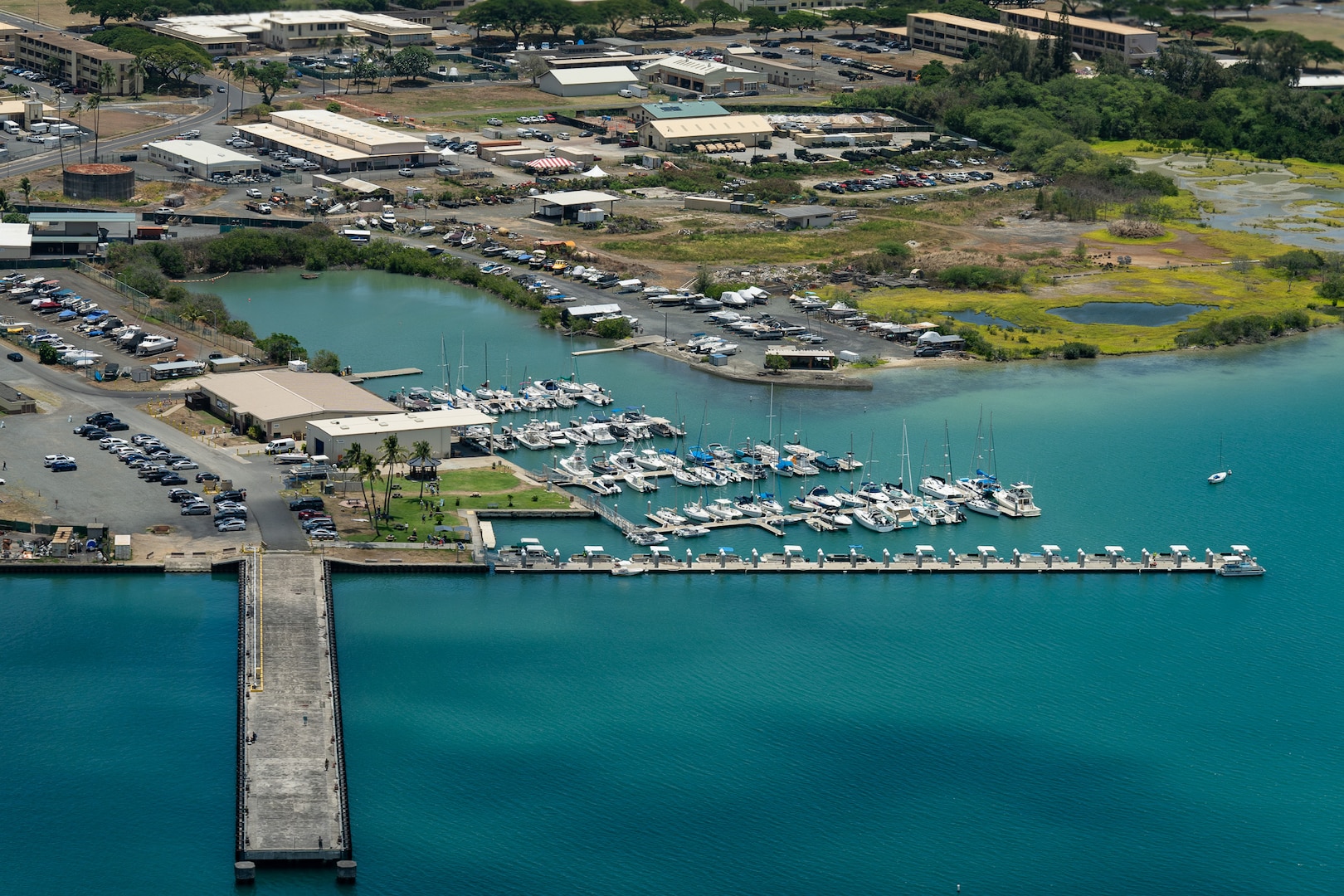 An HC-130 Hercules crew from Coast Guard Air Station Barbers Point observes Kaneohe Bay Base Marina, Oahu, July 30, 2025. The Coast Guard Captain of the Port Honolulu reopened all commercial harbors in Hawaii after the end of a tsunami advisory that had been issued for the state of Hawaii. (U.S. Coast Guard photo by Petty Officer 3rd Class Avery Tibbets)