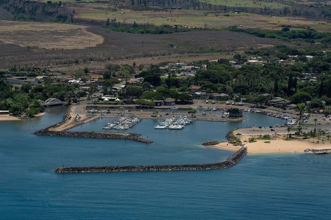 A crew from Coast Guard Air Station Barbers Point observes Haleiwa Harbor, Oahu, from an HC-130 Hercules, July 30, 2025. The crew flew over a number of the Hawaiian Islands to assess the condition of harbors, waterways and aids to navigation following the end of a tsunami advisory that had been issued for the State of Hawaii. (U.S. Coast Guard photo by Petty Officer 3rd Class Avery Tibbets).