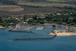 A crew from Coast Guard Air Station Barbers Point observes Haleiwa Harbor, Oahu, from an HC-130 Hercules, July 30, 2025. The crew flew over a number of the Hawaiian Islands to assess the condition of harbors, waterways and aids to navigation following the end of a tsunami advisory that had been issued for the State of Hawaii. (U.S. Coast Guard photo by Petty Officer 3rd Class Avery Tibbets).