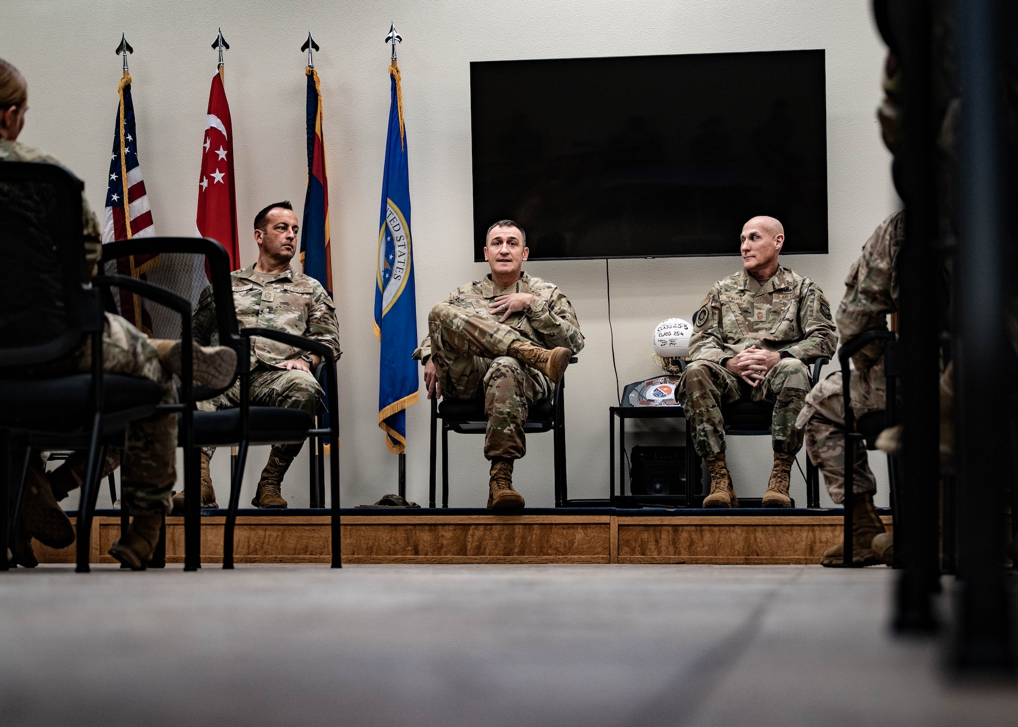 U.S. Air Force Chief Master Sgts. Keith Scott (left), 19th Air Force command chief, Nathan Chrestensen (middle), 56th Fighter Wing command chief, and Jamie Newman (right), Headquarters Air Mobility Command command chief, talk to Airman Leadership School students