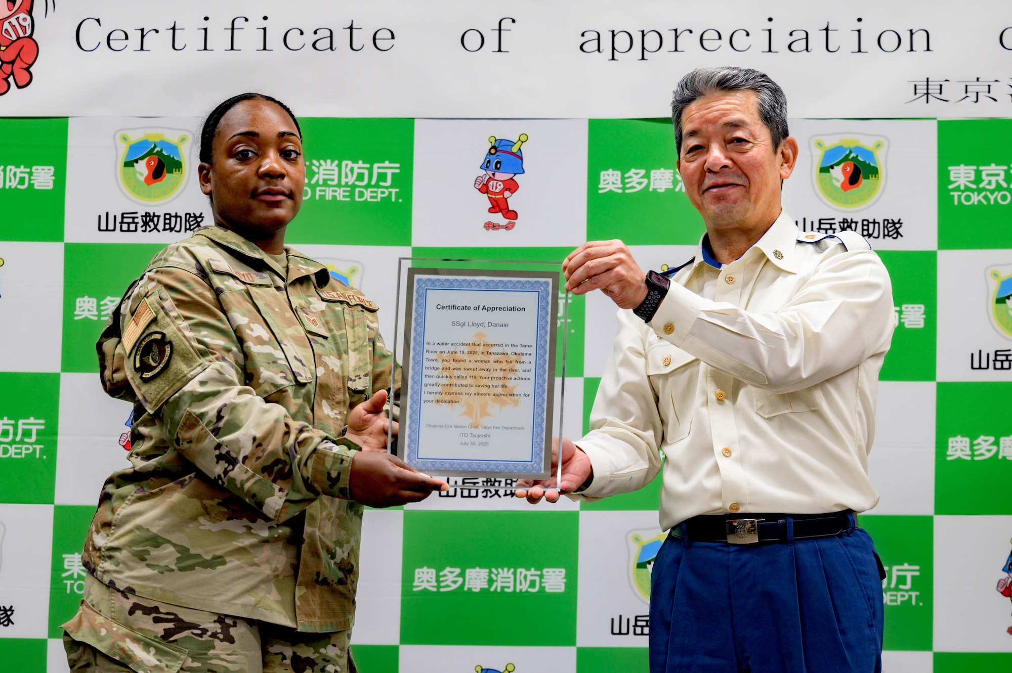 From the left, U.S. Air Force Danaie Lloyd, 374th Logistics Readiness Squadron inventory inspection supervisor NCOIC, receives a certificate of appreciation from Tsuyoshi Ito, Okutama fire department fire chief at Okutama, Japan, July 30, 2025. Events like these demonstrate the enduring partnership between Yokota Air Base and the surrounding Japanese communities, built on trust, shared experiences, and mutual support.