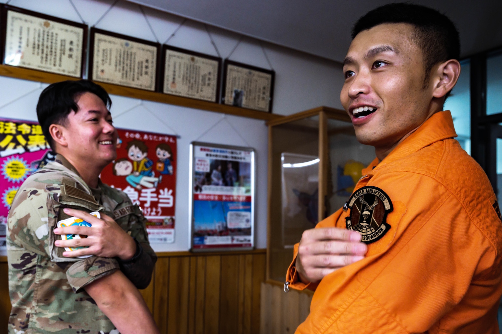From left, U.S. Air Force Senior Airman Malachi Mustango, 36th Airlift Squadron resource advisor, and Kazuki Nishikawa, Okutama Fire Department, firefighter, trade patches in Okutama, Japan, July 30, 2025. Patch exchanges are a long-standing tradition that symbolize mutual respect and camaraderie between service members and their international counterparts. (U.S. Air Force photo by Staff Sgt. Manuel G. Zamora)