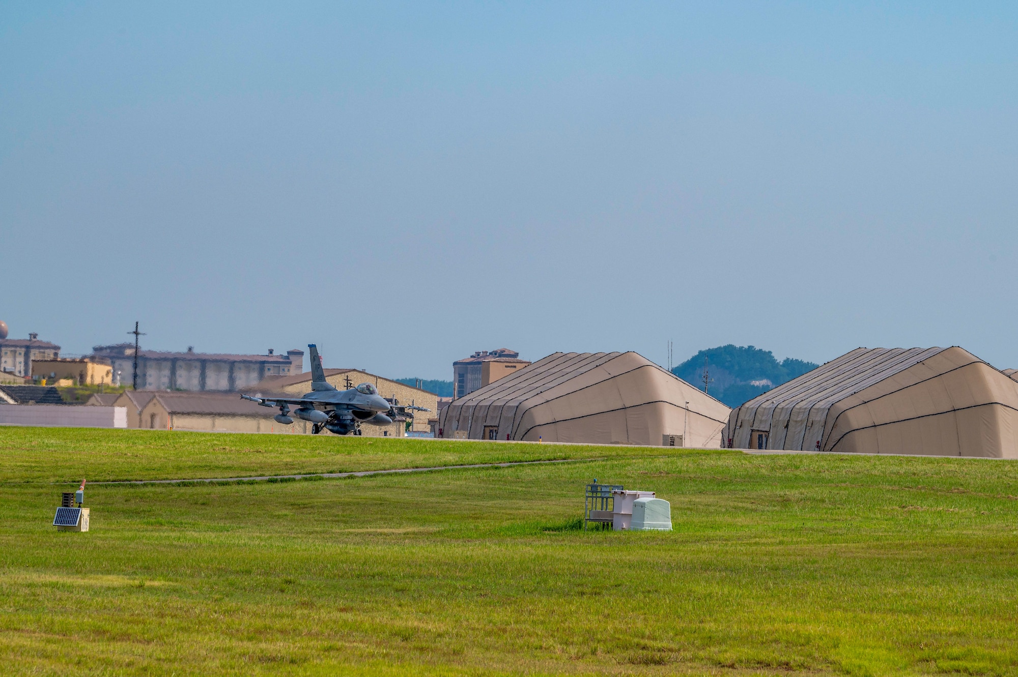 A 35th Fighter Squadron F-16 Fighting Falcon aircraft taxis across a taxiway