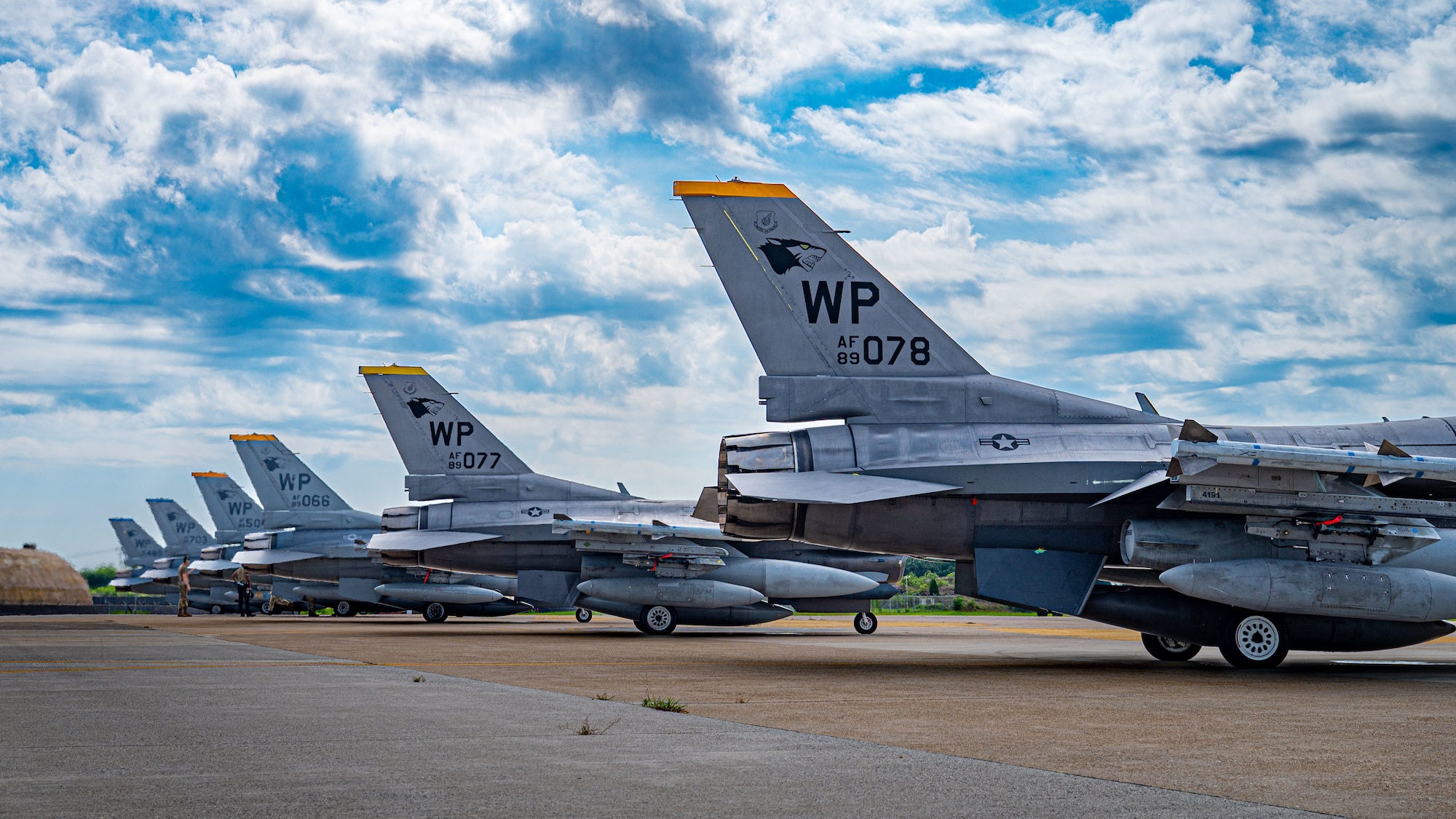 A flight F-16 Fighting Falcon aircraft sit for a weapons check prior to takeoff