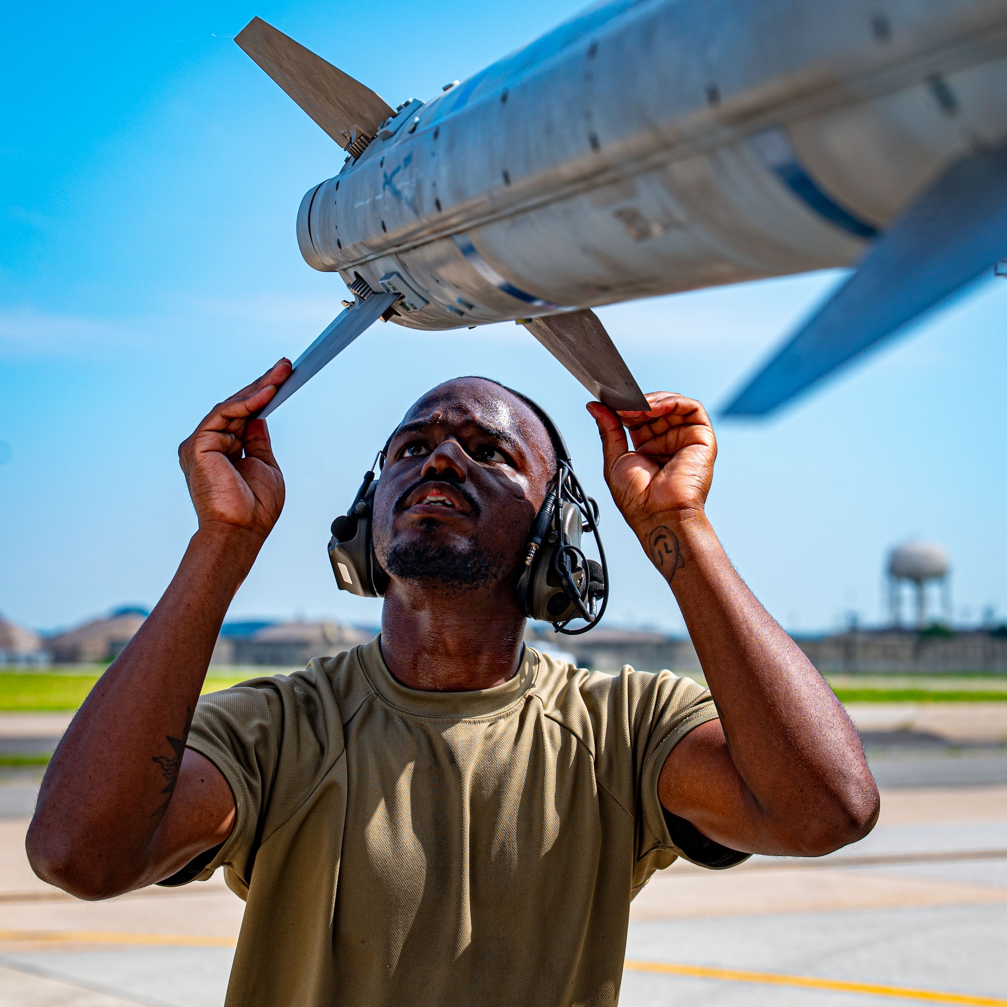 A member of the 35th Maintenance Squadron double checks hard point mounts on a 35th Fighter Squadron F-16 Fighting Falcon