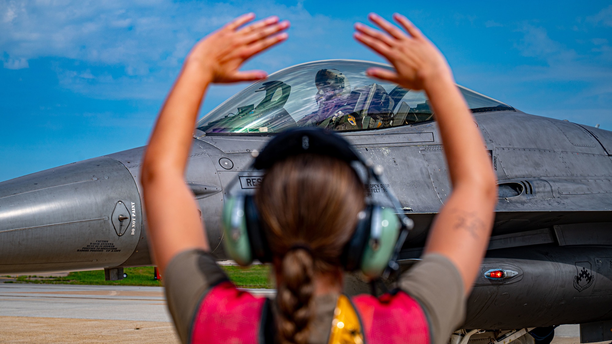 A maintainer marshals a jet