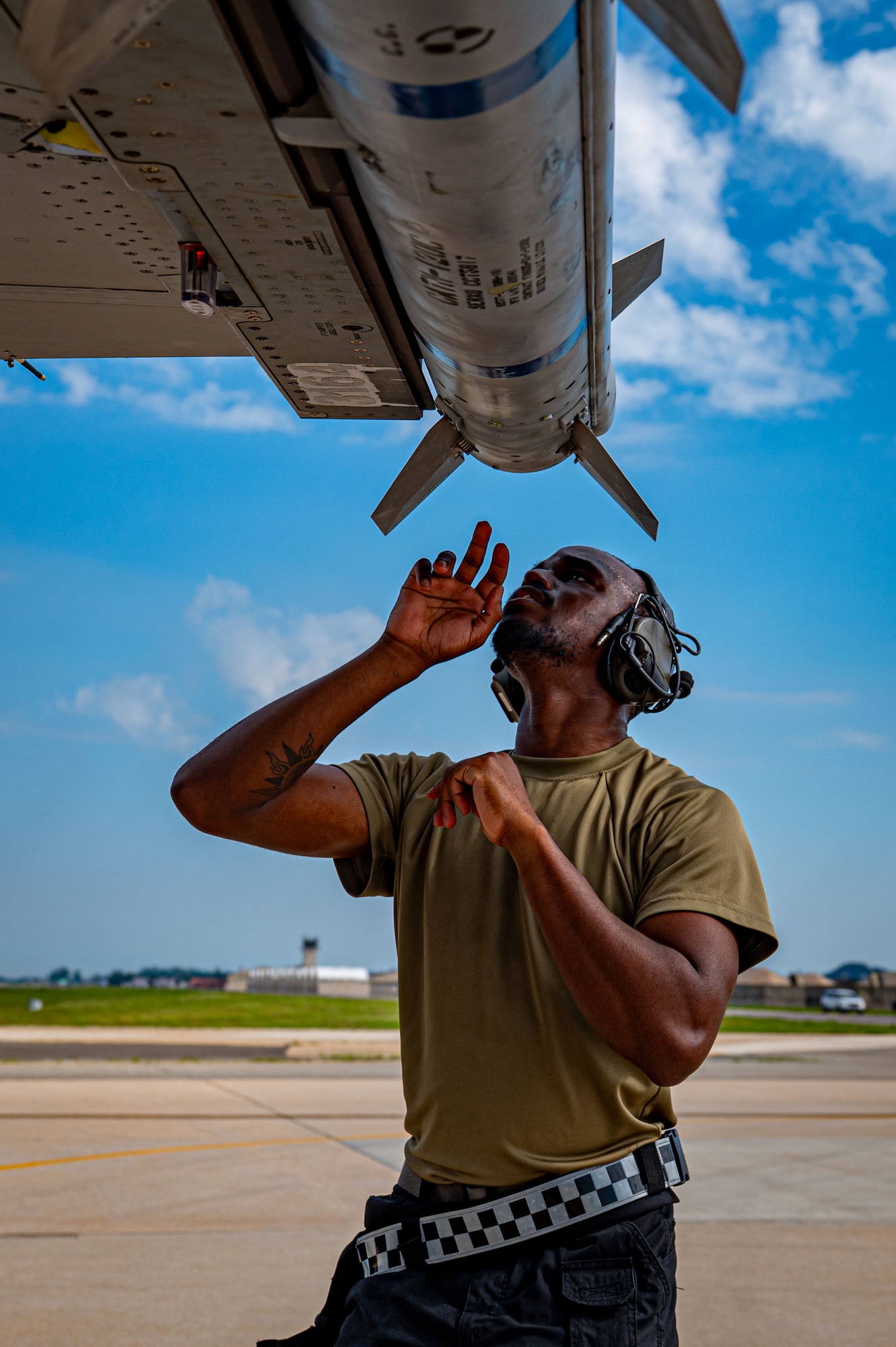 Airman checks jet mounting
