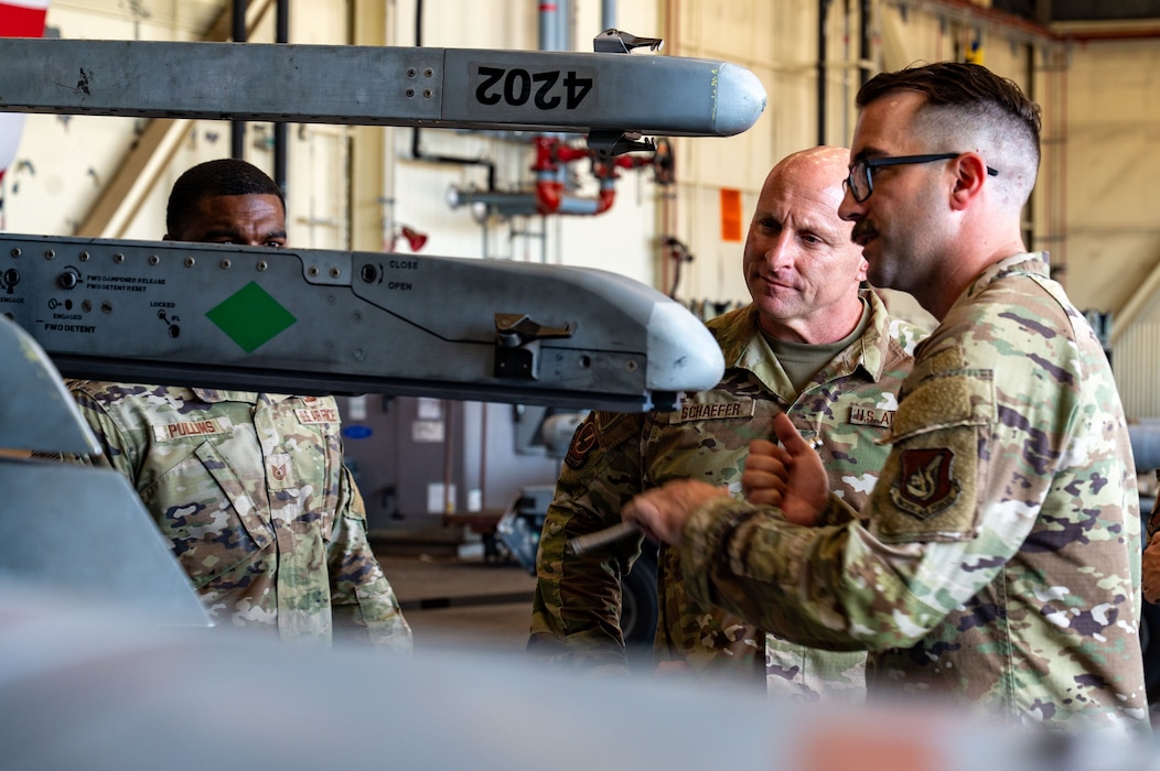 Chief Master Sgt. Thomas Schaefer II, Seventh Air Force command chief, and Tech. Sgt. Branden Genovese, 8th Maintenance Group loading standardization crew member, discuss F-16 Fighting Falcon hardpoint capabilities at Kunsan Air Base, Republic of Korea, July 29, 2025. Schaefer’s multi-day visit included leadership briefings, lunch discussions, unit immersion demonstrations and an all-call.