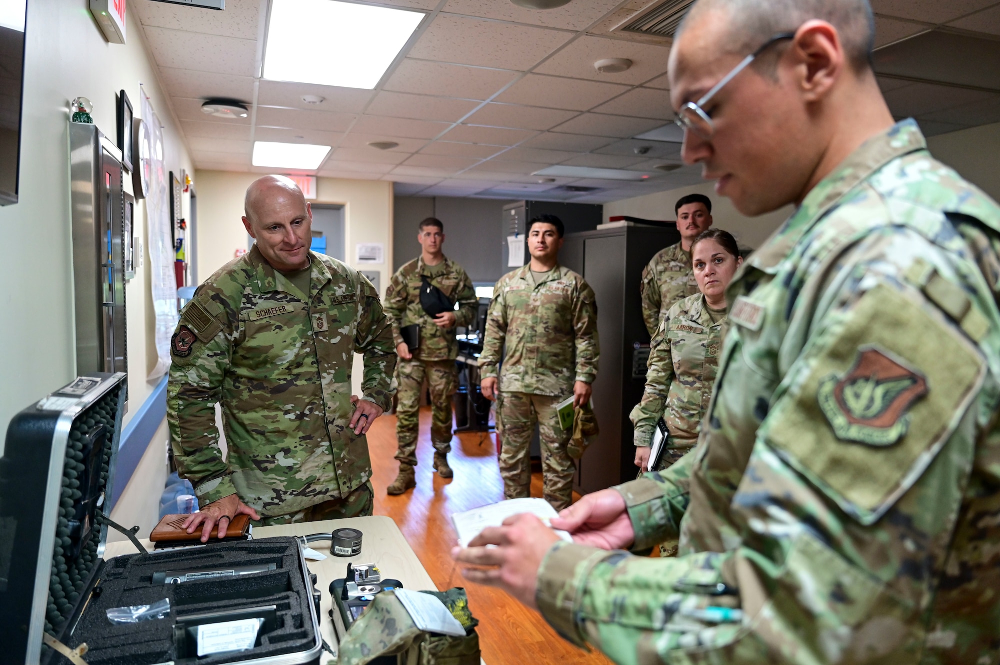 Chief Master Sgt. Thomas Schaefer II, Seventh Air Force command chief, listens as an Airman explains how to use a chemical and biological testing kit at Kunsan Air Base, Republic of Korea, July 29, 2025. Schaefer learned about the 8th Medical Group’s bioenvironmental engineers and how they perform health risk assessments for everyone on base to keep them safe from potential environmental and occupational exposures.