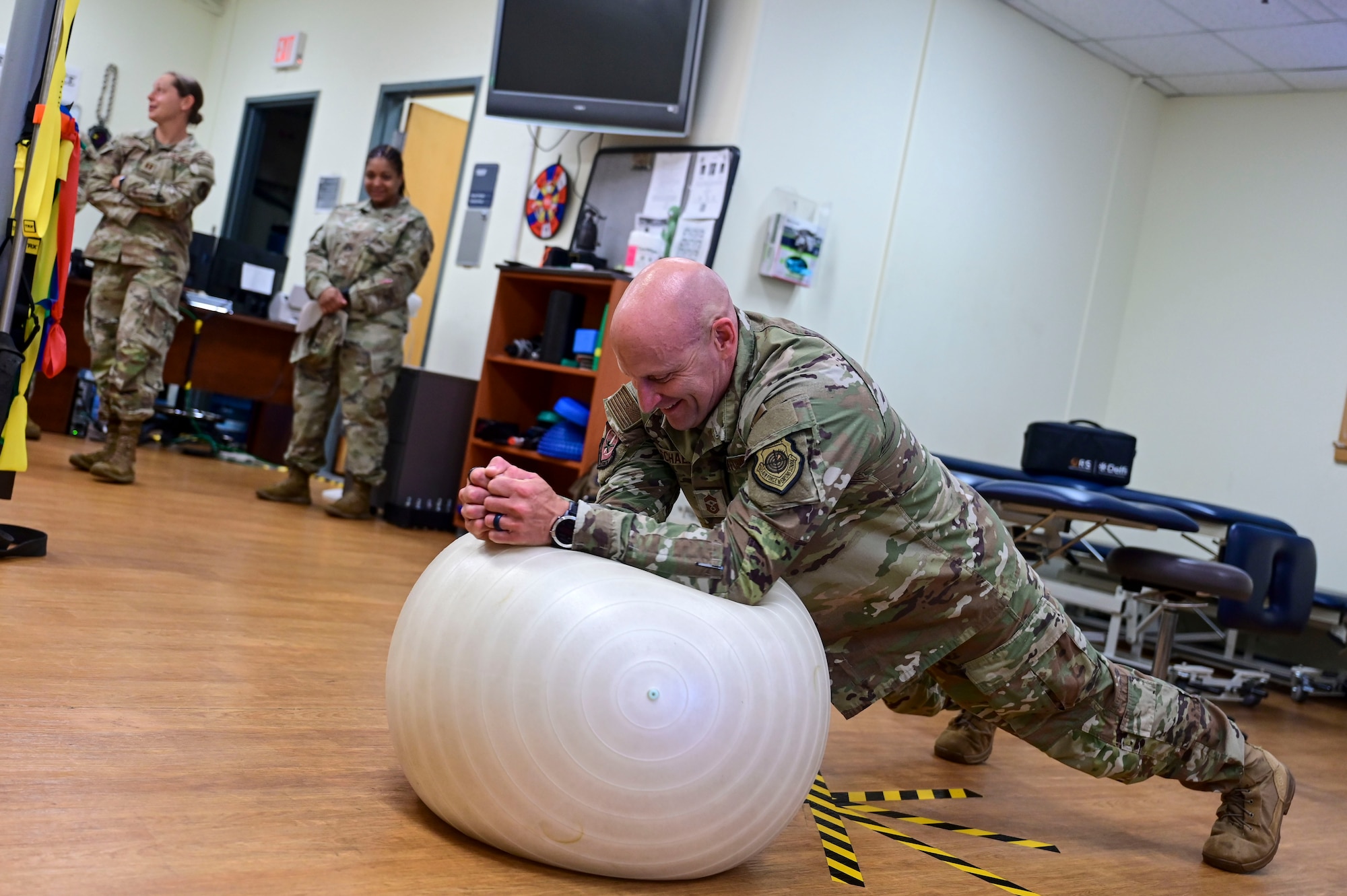 Chief Master Sgt. Thomas Schaefer II, Seventh Air Force command chief, practices a stability plank exercise during a visit to the 8th Medical Group human performance flight at Kunsan Air Base, Republic of Korea, July 29, 2025. The intent of this multi-day visit was to learn about the base, the various unit missions and the Airmen who support them.