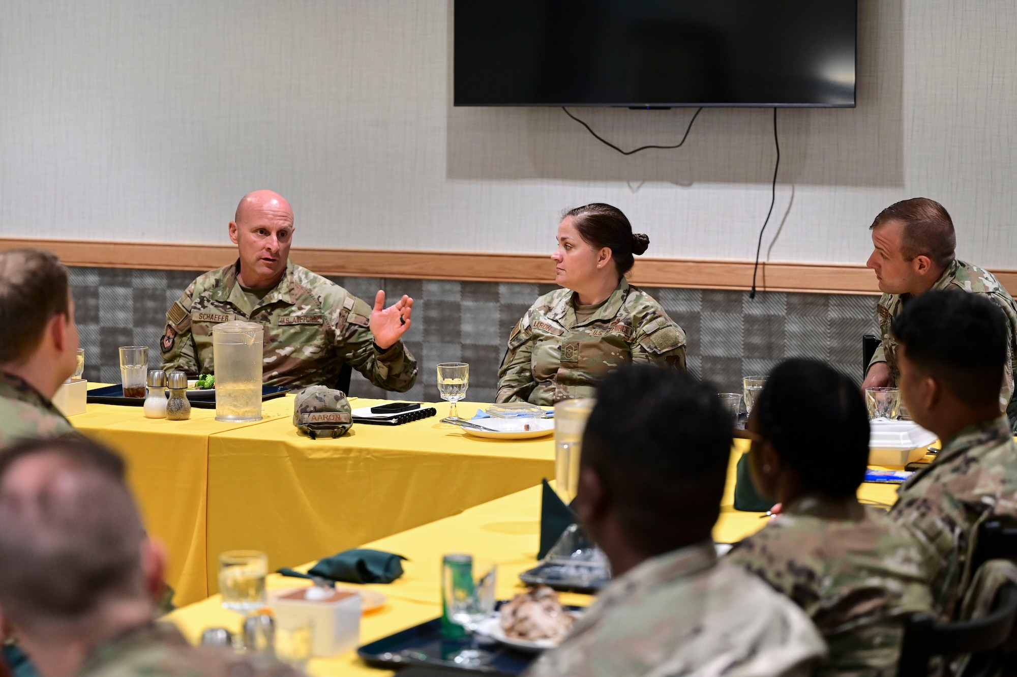 Chief Master Sgt. Thomas Schaefer II, Seventh Air Force command chief, and Chief Master Sgt. Amanda Aaron, 8th Fighter Wing command chief, speak to noncommissioned officers during a mentorship lunch at Kunsan Air Base, Republic of Korea, July 30, 2025. This visit provided the Wolf Pack Airmen an opportunity to engage directly with Seventh Air Force leadership.