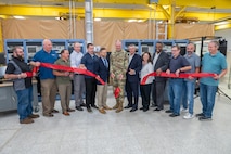 Photo of a group of people cutting the ribbon