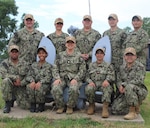 OKLAHOMA CITY (July 2025) – Sailors assigned to the Adaptive Mobilization Medical Unit (AMMU) PAC along with Cmdr. Elisa Martinez of REDCOM Fort Worth pose for a group photo during a Mobilization Exercise (MOBEX) held at Navy Reserve Center Oklahoma City. The AMMU provides critical medical screening and readiness support to ensure Navy Reserve personnel are medically qualified for rapid deployment. (U.S. Navy courtesy  photo by Lt. Cmdr. Alice Richards )