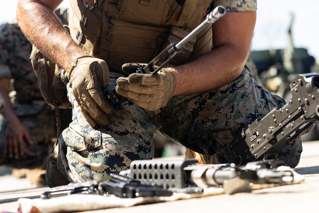 U.S. Marine Corps Cpl. Noah Bartholomew, a motor transportation operator with 2nd Medical Battalion, 2nd Marine Logistics Group, demonstrates how to disassemble a M240B machine gun at Marine Corps Base Camp Lejeune, July 28, 2025. Motor transportation Marines train in vehicle proficiency, convoy tactics, cargo handling, navigation, communication, and emergency procedures to ensure timely, secure, and efficient transportation support. Bartholomew is a native of Benson, Vermont. (U.S. Marine Corps photo by Sgt. Makayla Elizalde)