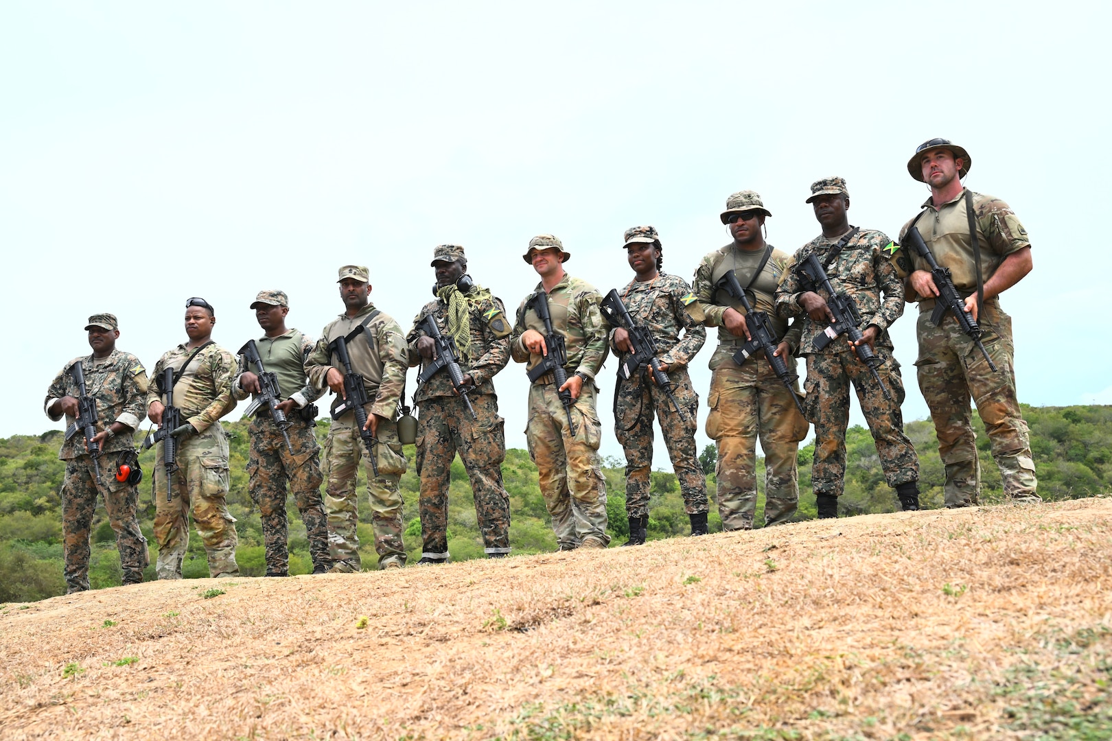 Soldiers from the D.C. National Guard, Barbados Defence Force Reserves, Jamaica Defence Force, and Jamaica National Reserve stand for a photograph at Twickenham Park Range in St. Catherine, Jamaica, on July 17, 2025. As part of the Caribbean Regional Training Camp, activities included zeroing, firing from different positions, march-and-shoot practice, and a march-and-shoot competition. The District of Columbia National Guard's (DCNG) partnership with Jamaica, facilitated by the U.S. National Guard Bureau's State Partnership Program (SPP), promotes security cooperation through military engagements and interagency collaboration.