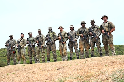 Soldiers from the D.C. National Guard, Barbados Defence Force Reserves, Jamaica Defence Force, and Jamaica National Reserve stand for a photograph at Twickenham Park Range in St. Catherine, Jamaica, on July 17, 2025. As part of the Caribbean Regional Training Camp, activities included zeroing, firing from different positions, march-and-shoot practice, and a march-and-shoot competition. The District of Columbia National Guard's (DCNG) partnership with Jamaica, facilitated by the U.S. National Guard Bureau's State Partnership Program (SPP), promotes security cooperation through military engagements and interagency collaboration.