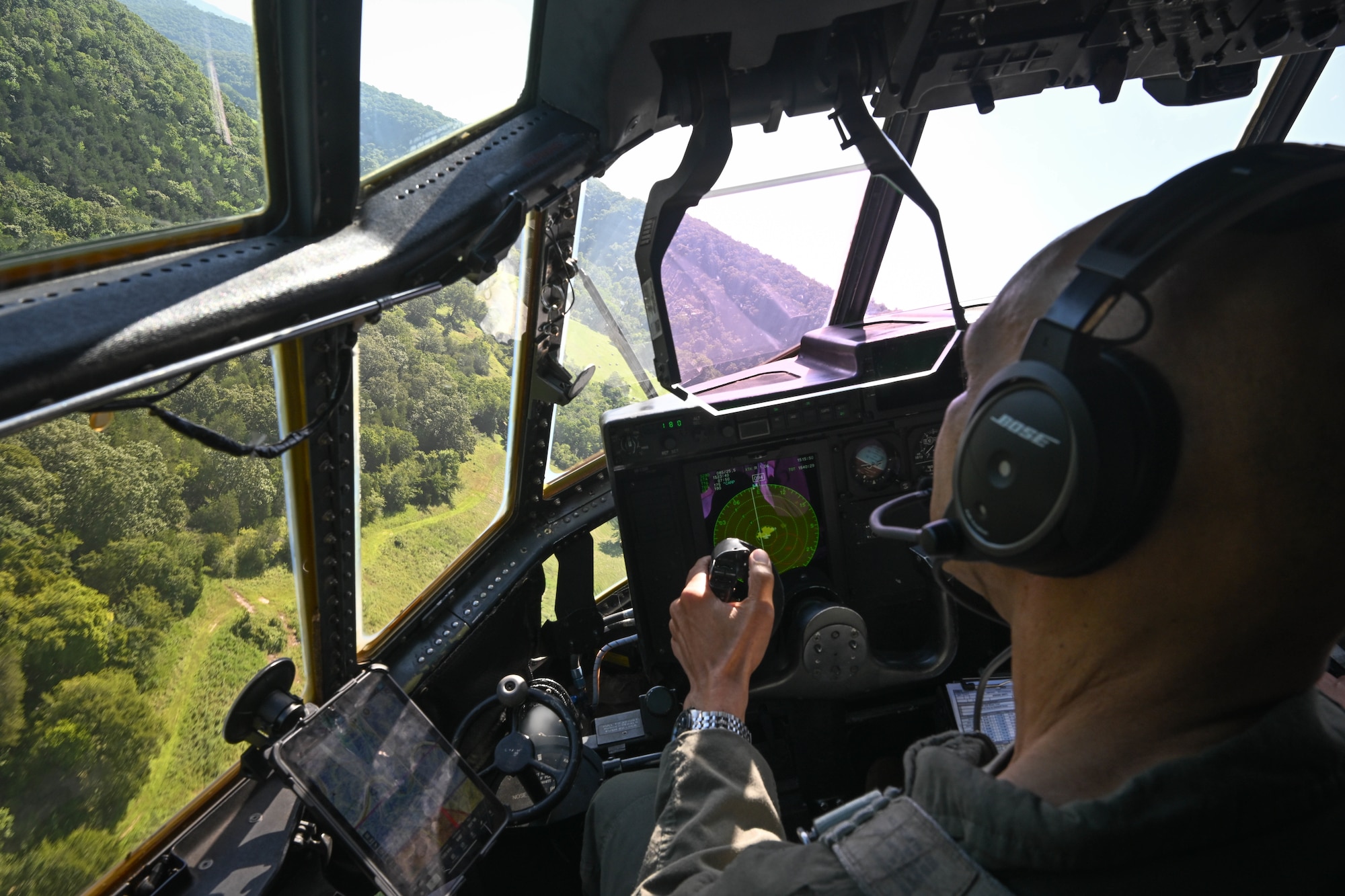 A man in uniform flies a plane.