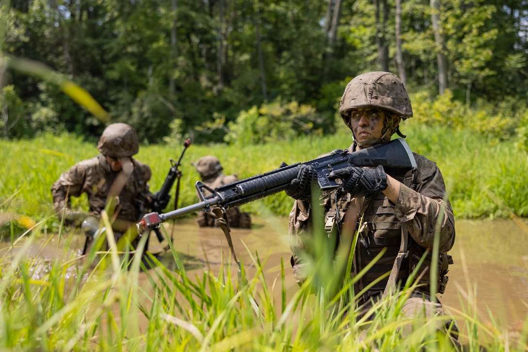 A U.S. Marine Corps officer candidate holds security while traversing “The Quigley” during the Forge at Officer Candidate School, on Marine Corps Base Quantico, Virginia, July 23, 2025. The Forge is a culminating event designed to test candidates’ endurance, leadership and resilience under pressure involving day and night hikes, simulated indirect fire, sleep deprivation, obstacle navigation and team-based exercises. (U.S. Marine Corps photo by Sgt. Dean Gurule)
