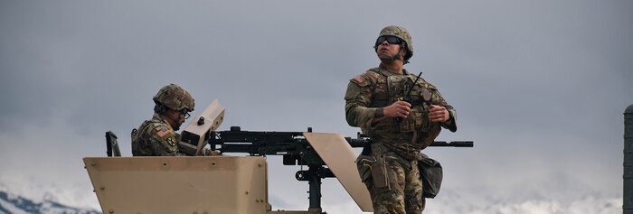 two soldiers inside a military vehicle