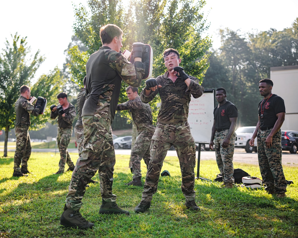 British Royal Marines conduct hand-to-hand combat techniques during a physical training circuit as part of “Virginia Tempest” at The Basic School on Marine Corps Base Quantico, Virginia, July 30, 2025. Virginia Tempest is an annual training event where Royal Marines and U.S. Marines collaborate in training such as the obstacle course, Marine Corps Martial Arts Program, and other rigorous events, ultimately designed to support interoperability and maintaining the historic working relationship between the organizations. (U.S. Marine Corps photo by Lance Cpl. Braydon Rogers)