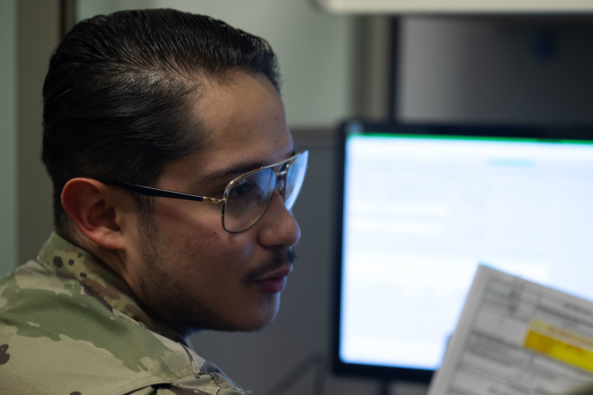 Senior Airman Bryan Ponce-Cisneros processes financial paperwork.