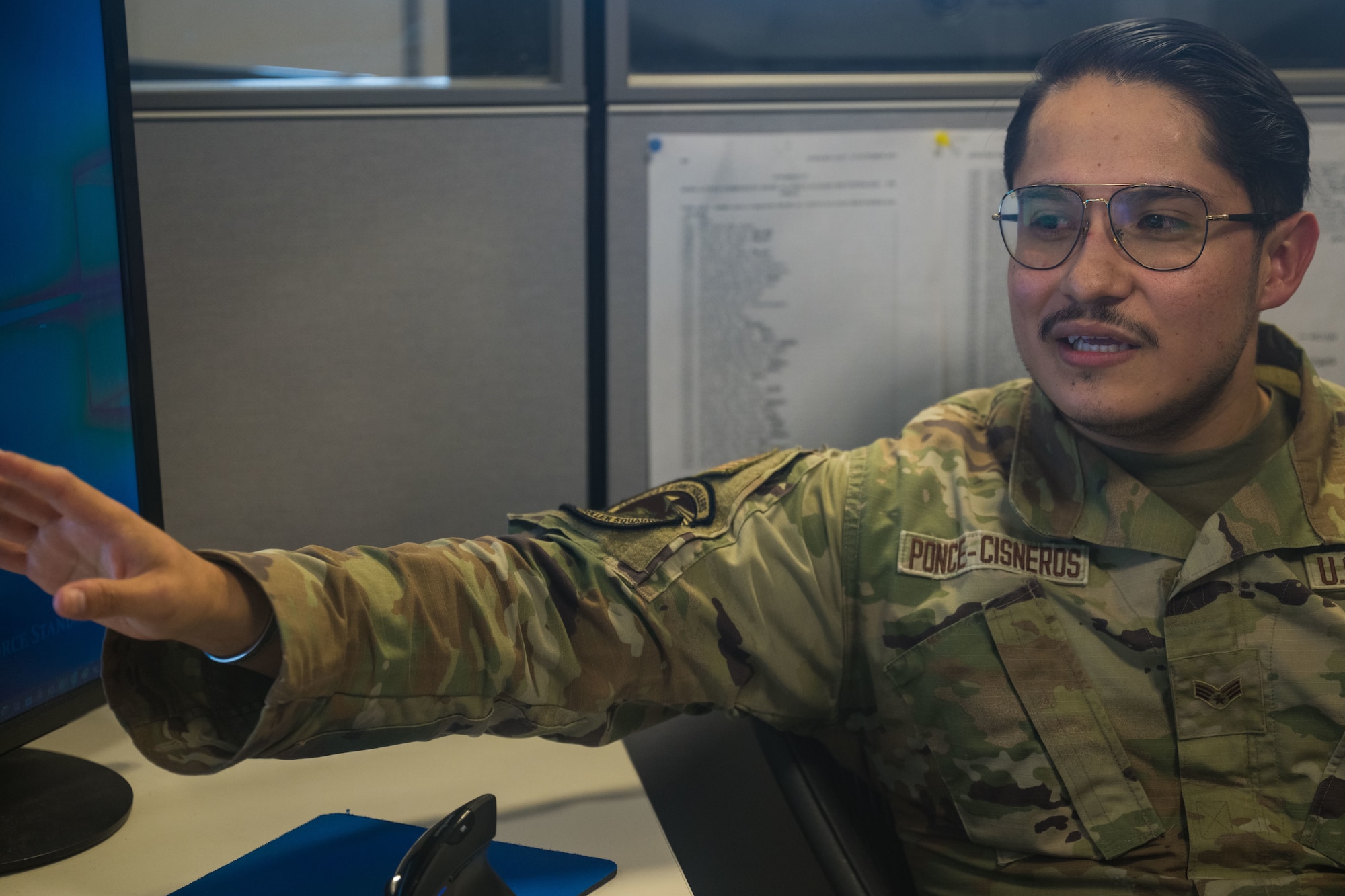 Senior Airman Bryan Ponce-Cisneros gives an overview of is daily operations to wing leadership.