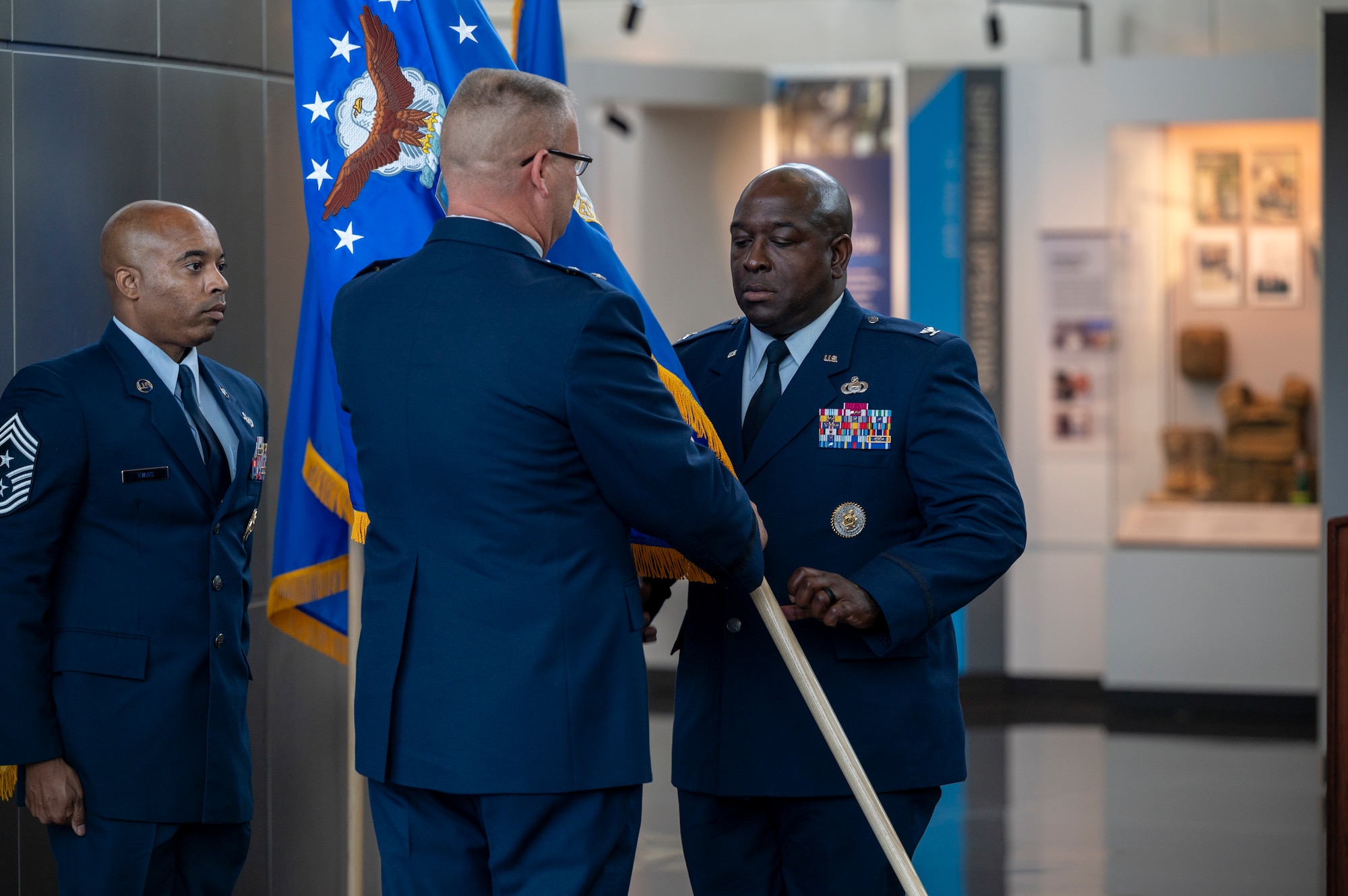 U.S. Air Force Maj. Gen. Daniel A. DeVoe, Air Force District of Washington and 320th Air Expeditionary Wing commander, passes the Air Force Provisional Flag, to Col. Ryan L. O’Neal, new commander of the 77th Intelligence Wing during the 77th IW Activation and Assumption of Command Ceremony at Joint Base Anacostia-Bolling, Washington, D.C., July 24, 2025.