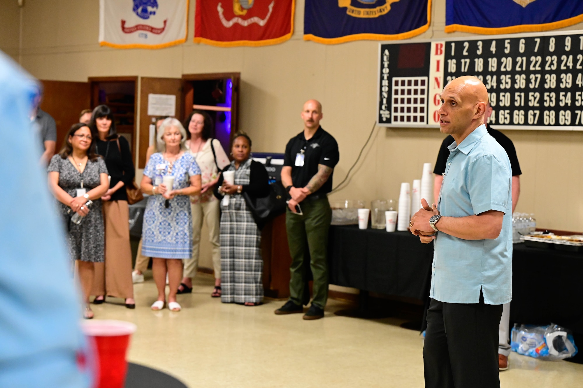 A man speaks in front of a group of people.